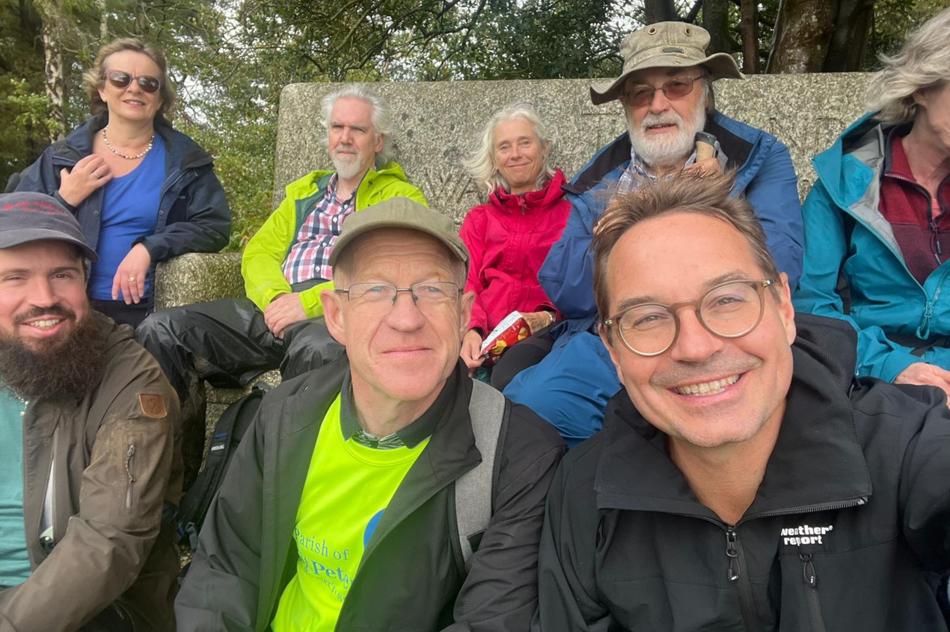 The Viborg and Guildford pilgrims pose for a selfie whilst taking a rest on a stone bench