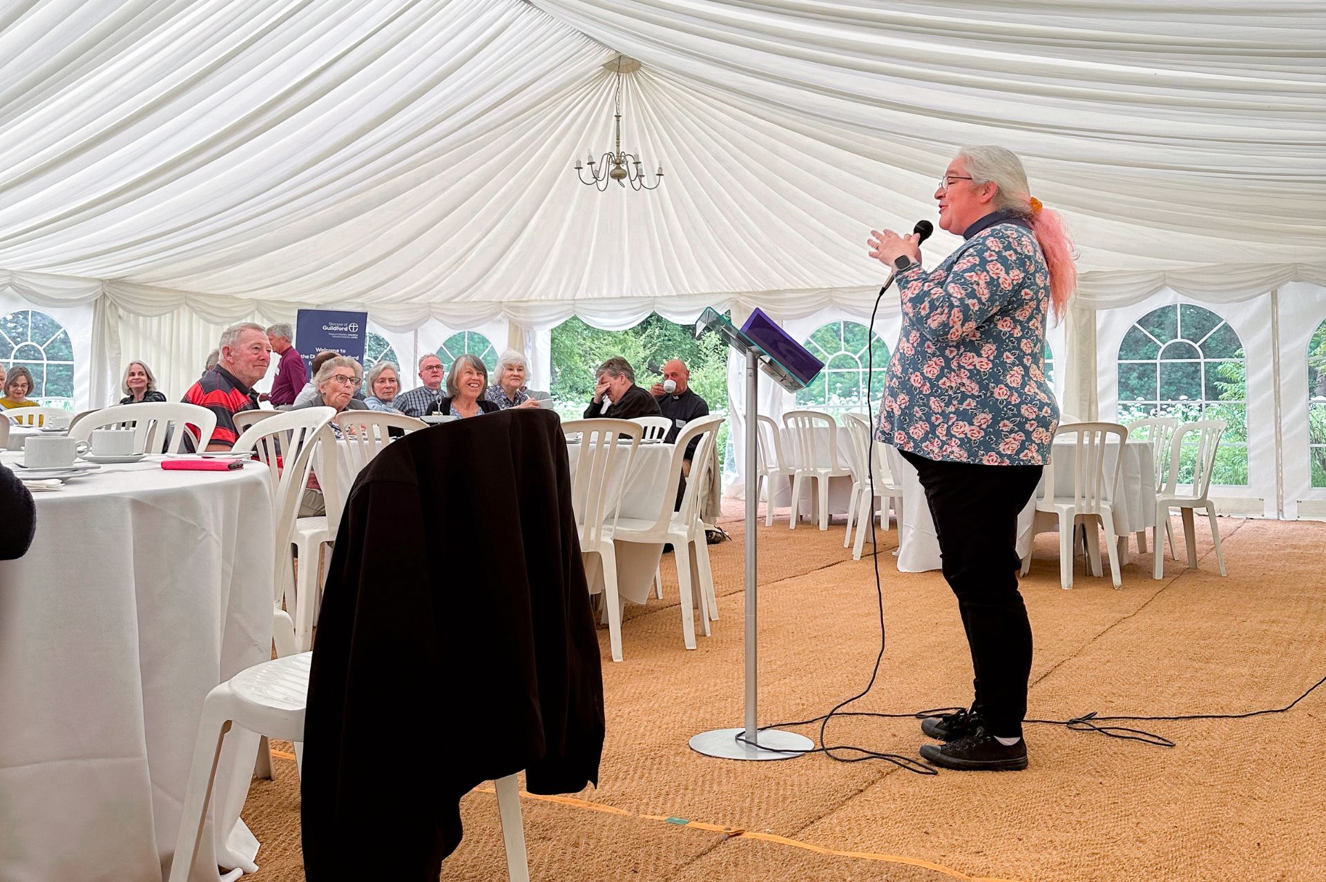 Beki Rogers addresses the attendees of the Listening Well Tent Week event