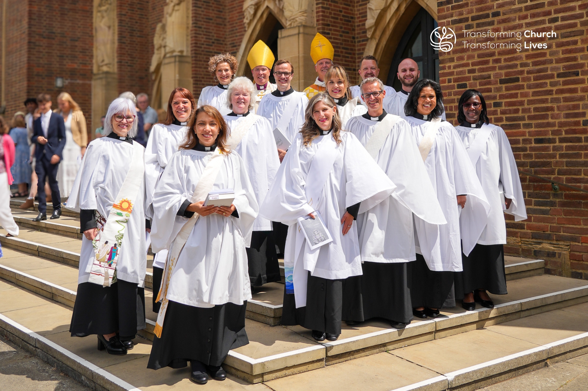 The 9 women and 4 men who became deacons in the Diocese of Guildford in 2025 stand with Bishop Andrew and Bishop Paul outside Guildford Cathedral