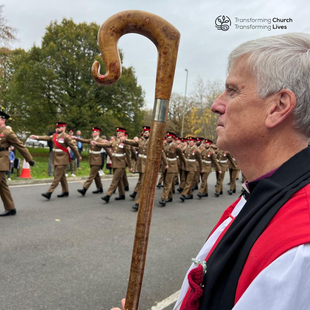 Bishop Andrew Watson standing watching armed forces parade of Remembrance Sunday