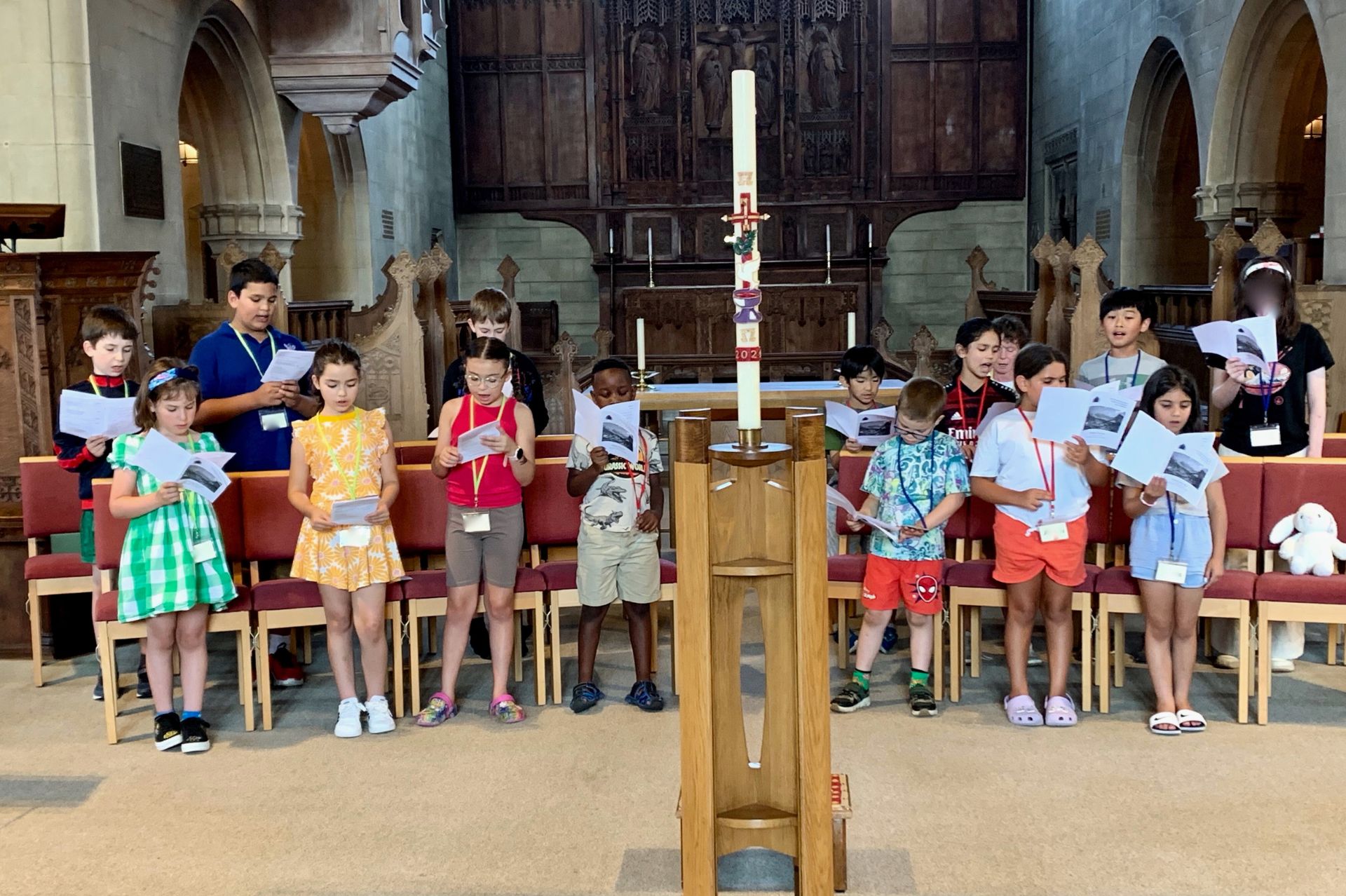 A group of children sing in a church