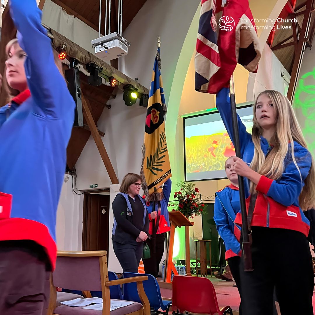 Guides parading with flags at Christ Church Cove