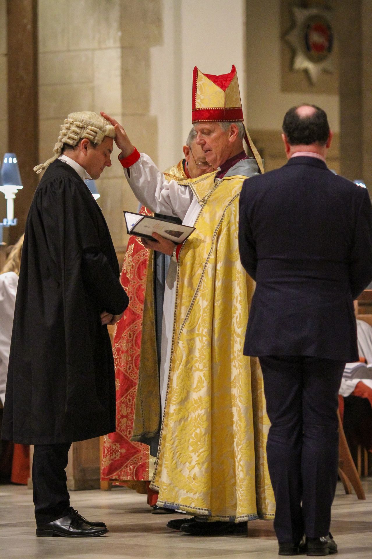 Bishop Andrew Watson prays for Kevin Wilson as he formally welcomes him and Richard Hastings as Registrar and Registry Clerk to the Diocese of Guildford