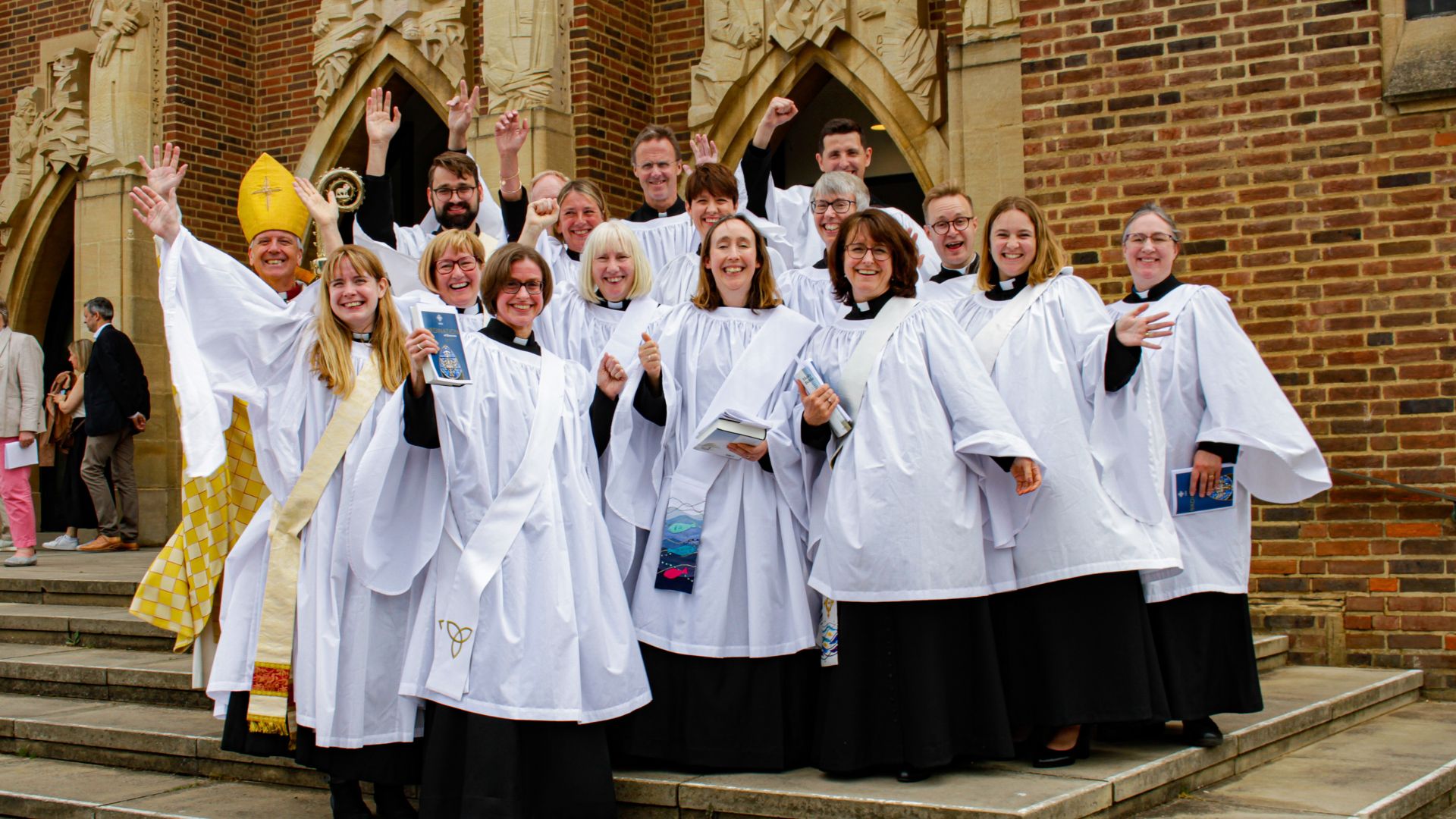 Deacons in full clerical attire celebrate their ordination with Bishop Andrew