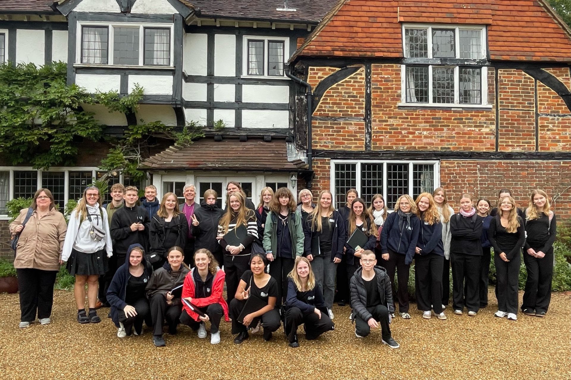 The Viborg Choir from Denmark pose with Bishop Andrew Watson outside Willow Grange